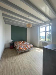 a bedroom with a bed in the middle of a room at gite de caractere dans maison de campagne in Ayherre
