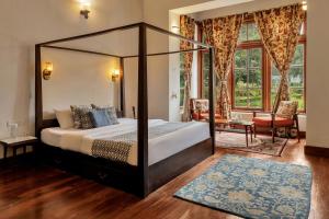 a bedroom with a canopy bed in a room at SaffronStays Milton Abbott Estate, Ooty in Ooty