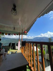 a porch with a table and a view of the mountains at Walk in Himalayas in Pelling