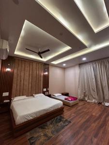 a bedroom with two beds and a ceiling at The Satluj Vista in Bilāspur