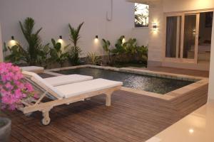 a pool in a house with a bench and a table at the gosana in Amed