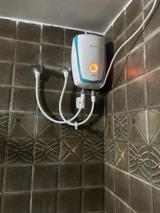 a soap dispenser on a tiled wall at Markandey Bhavan in Deoghar