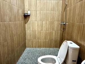 a small bathroom with a toilet and a shower at Arkatama Lumbung Bali in Onggokanbatue