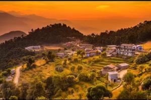une peinture d'un village avec des maisons sur une colline dans l'établissement The Hotel Orchid & Restaurant, à Kāskī