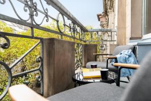 a balcony with chairs and a table with a book at TRIBE Düsseldorf in Düsseldorf