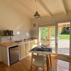 a kitchen with a table and a dining room at Inti Laufquen in San Carlos de Bariloche +10 photos