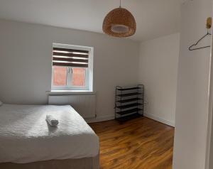 a bedroom with a bed and a window at Large Double Room in Longbridge