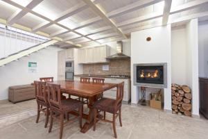 a kitchen with a table and chairs and a fireplace at Residenza San Marco in Viterbo