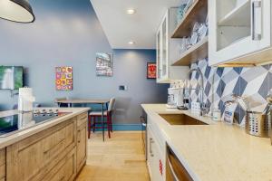 cocina con paredes azules y armarios de madera en Island Retreat, en Key West 19 fotos más