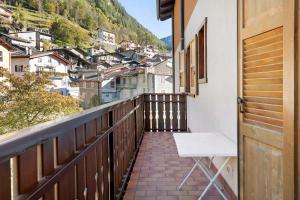 a balcony with a table and a view of a city at Super Mini Appartamento Lanzada in Lanzada