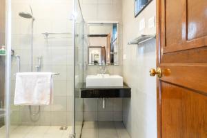 a bathroom with a sink and a glass shower at SaffronStays Milton Abbott Estate, Ooty in Ooty +30 photos