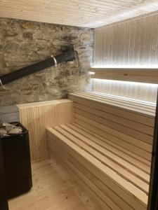 a sauna with a wooden tub with a window at Pension Pošta in Branná