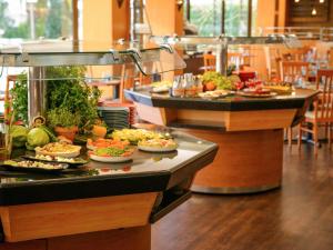 a buffet line with many different types of food at Novotel Porto Gaia in Vila Nova de Gaia
