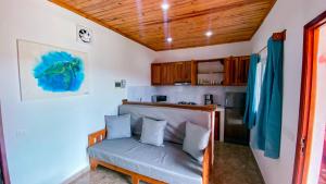 a small kitchen with a couch in a room at Jardin Fleuri de Lety in Nosy Be