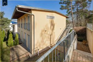 a building with a staircase next to a fence at Tema 11 in Ahlbeck