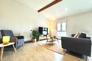 a living room with a couch and a tv at Le Cocon Céleste - Appartement d'Exception - Vue sur les Alpes - Centre-Ville - Gare à 1 min in Valence +24 photos