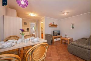 a living room with a table and chairs and a couch at Tema 14 in Ahlbeck +19 photos