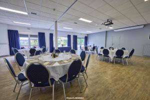 a conference room with tables and chairs in it at Hôtel du Golf Saint-Laurent in Ploemel +37 photos