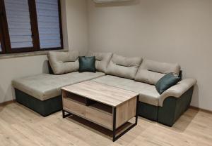 a living room with a couch and a coffee table at Ваканционен апартамент in Tryavna +1 photo