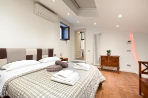a bedroom with a large bed with towels on it at Residenza San Marco in Viterbo