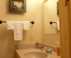 a bathroom with a sink and a mirror and towels at 8 Leisure in Sunriver +21 photos