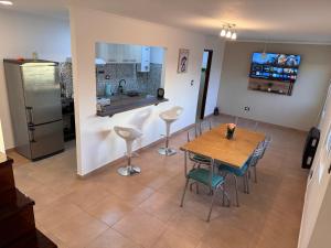a kitchen and dining room with a table and chairs at Asombroso departamento en zona centrica in Río Grande +31 photos