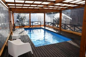 a swimming pool on the deck of a house at Tangerina Apart Hotel - Villa Gesell in Villa Gesell