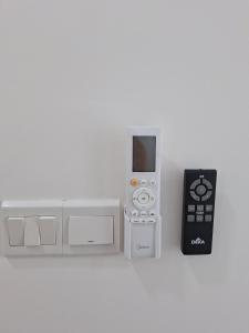 a nintendo wii game controller next to a remote control at MKH 2 New Era 1 Bed Room Up to 4 PAX in Kajang