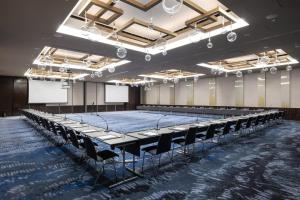 an empty room with a stage and chairs in it at InterContinental - Ljubljana by IHG in Ljubljana