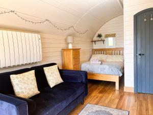 a living room with a couch and a bed at Woodland View in Rhayader