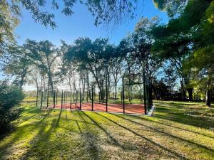 a batting cage in a field with trees at Château de Saü in Thuir