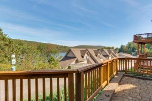 a wooden deck with a view of a house at Deep Creek Lake Townhome with Deck and Water Views in Oakland