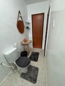 a bathroom with a toilet and a sink and a door at Oásis a 1km Parque COP30 in Belém