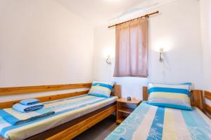 a bedroom with two beds and a window at Бунгала Гнездото Bungalows The Nest Lozenets 2 in Lozenets
