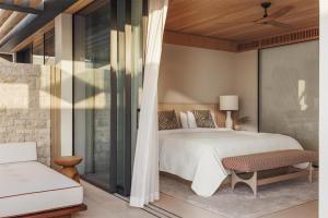 a bedroom with a large bed and a couch at One&Only Aesthesis, Athens in Athens