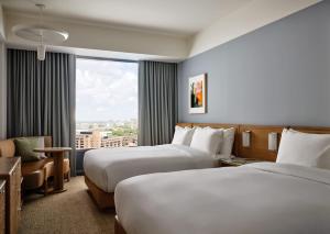 a hotel room with two beds and a window at The Atlas Hotel in Boston