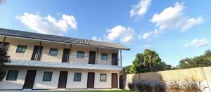 a building with a fence in front of it at Ko Lanta Hotels and Working Space in Ko Lanta