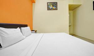 Postel nebo postele na pokoji v ubytování FabExpress Nova Rooms + 17 fotografií