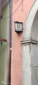 a clock on the side of a pink building at Ratusz Wroclaw in Wrocław
