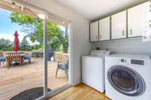 a washer and dryer in a laundry room with a deck at Point Lyle in Mosier