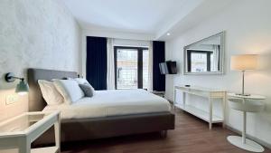 a bedroom with a large bed and a mirror at Prestige Rooms Chiaia in Naples