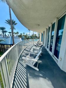 una fila di sedie a sdraio sul balcone di un edificio di A Dose of Vitamin Sea a Destin