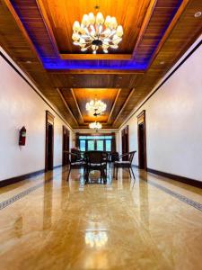 a dining room with a table and a ceiling at ZHOUhao HOTEL in Luang Prabang