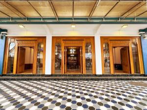 a room with a checkered floor in a building at ZHOUhao HOTEL in Luang Prabang +12 photos