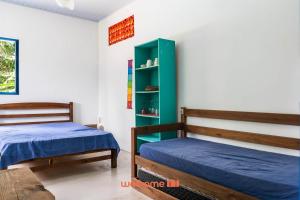 Postel nebo postele na pokoji v ubytování Kitnet em Aldeia Velha com piscina e churrasqueira