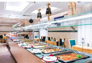 a buffet line with many different types of food at Grand Plaza Badr Al Maqam Fully Renovated in Medina