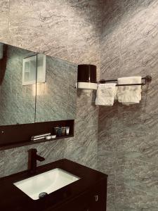 a bathroom with a sink and a mirror at فيلا وشاليه الجبل الاحمر in AlUla
