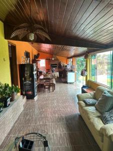 a living room with a couch and a table at Chácara São Marcos in Ibiúna