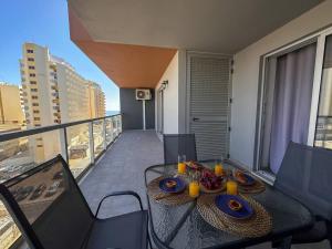 a dining table on the balcony of a apartment at Elite 7E - Vistas Mar na Praia da Rocha in Portimão