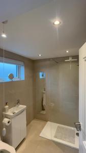 a bathroom with a glass shower and a sink at Derry City Apartment in Derry Londonderry +13 photos